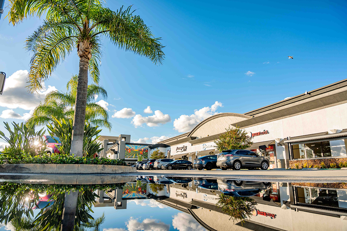 Exterior photo showing water way and front of stores