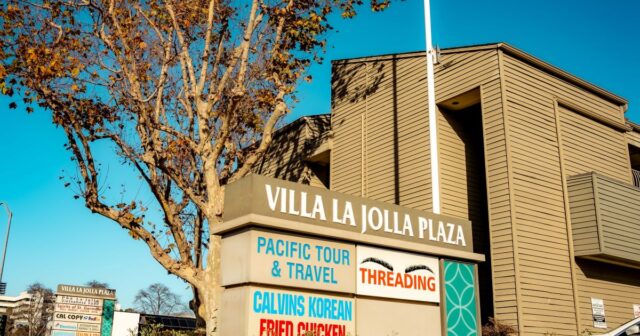 Monument sign showing sign panels for tenants at Villa La Jolla Plaza