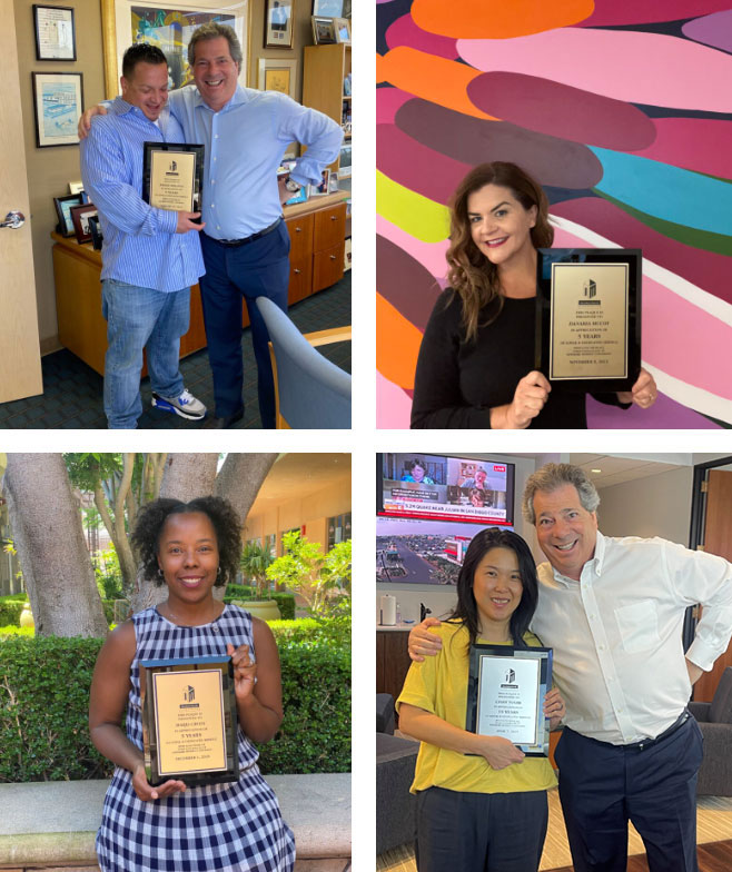 NewMark staff holding anniversary certificates